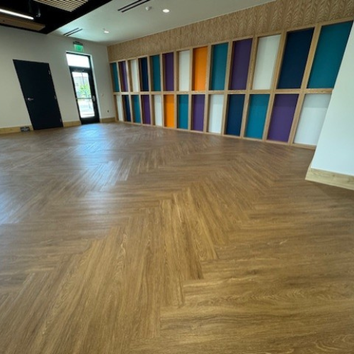 Herringbone patterned wood-look flooring in a community center
